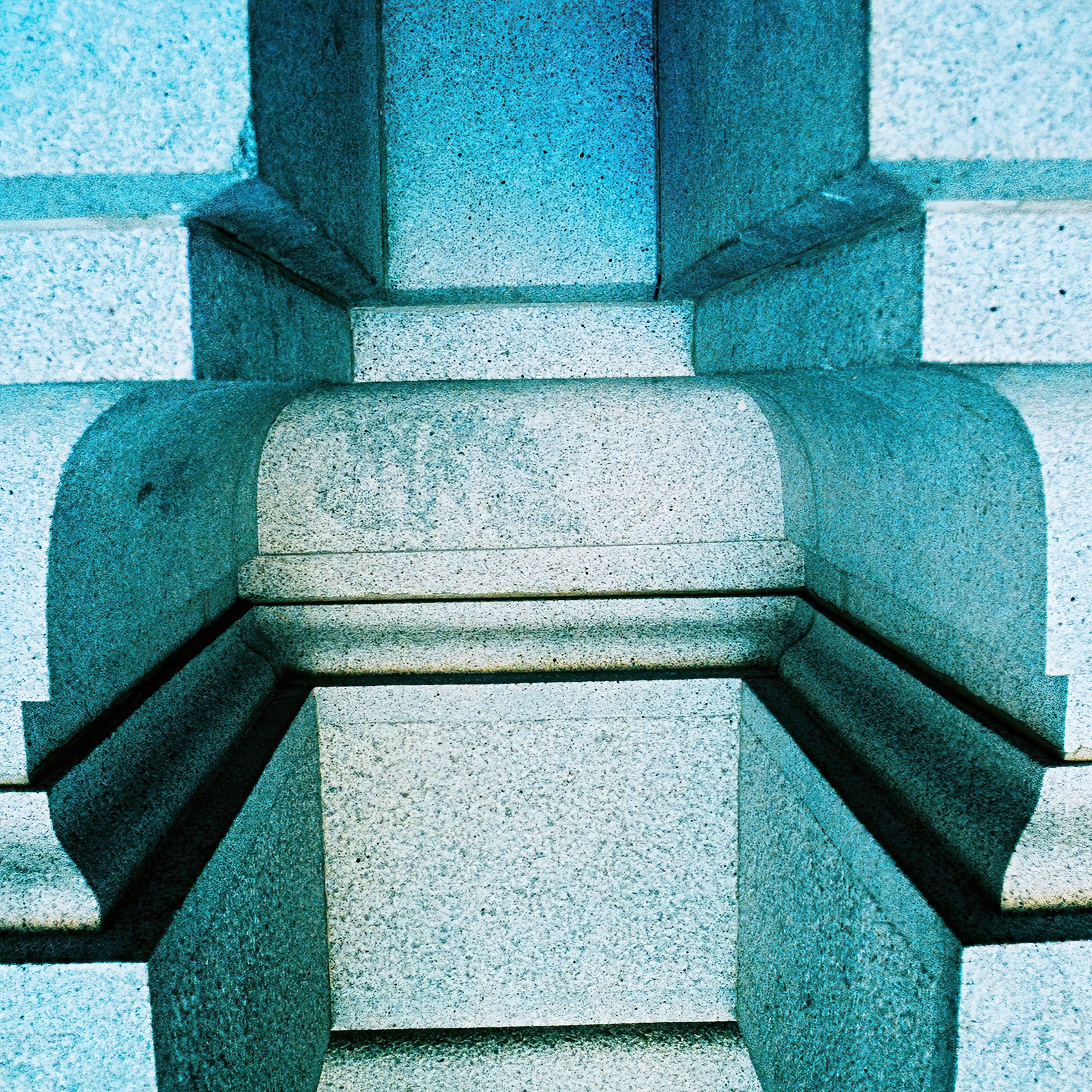 Beaux Parts architectural film photograph featuring a close-up of geometric stone facade details rendered in cool blue and turquoise tones.