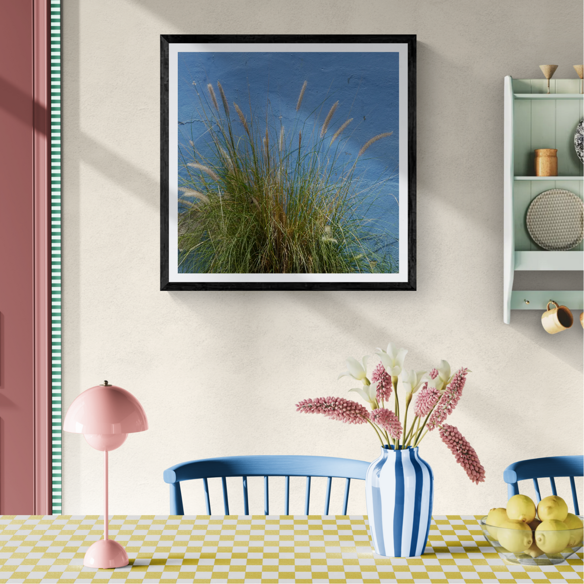 Blue Grass botanical photography art print displayed as 30 × 30 wall art in a black frame above a colorful dining table.