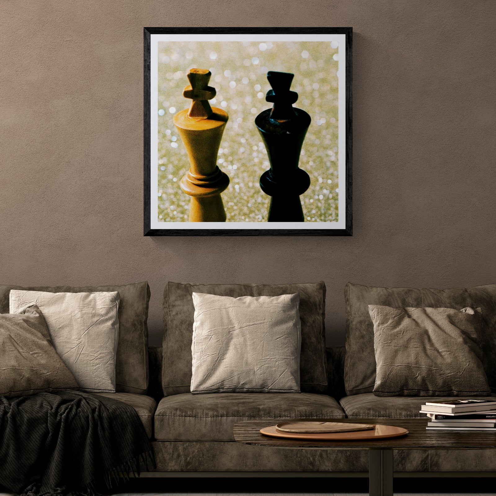 King Things film photograph of two chess kings in gold and black displayed as 30 × 30 wall art in a black frame above a neutral sofa in a modern living room.