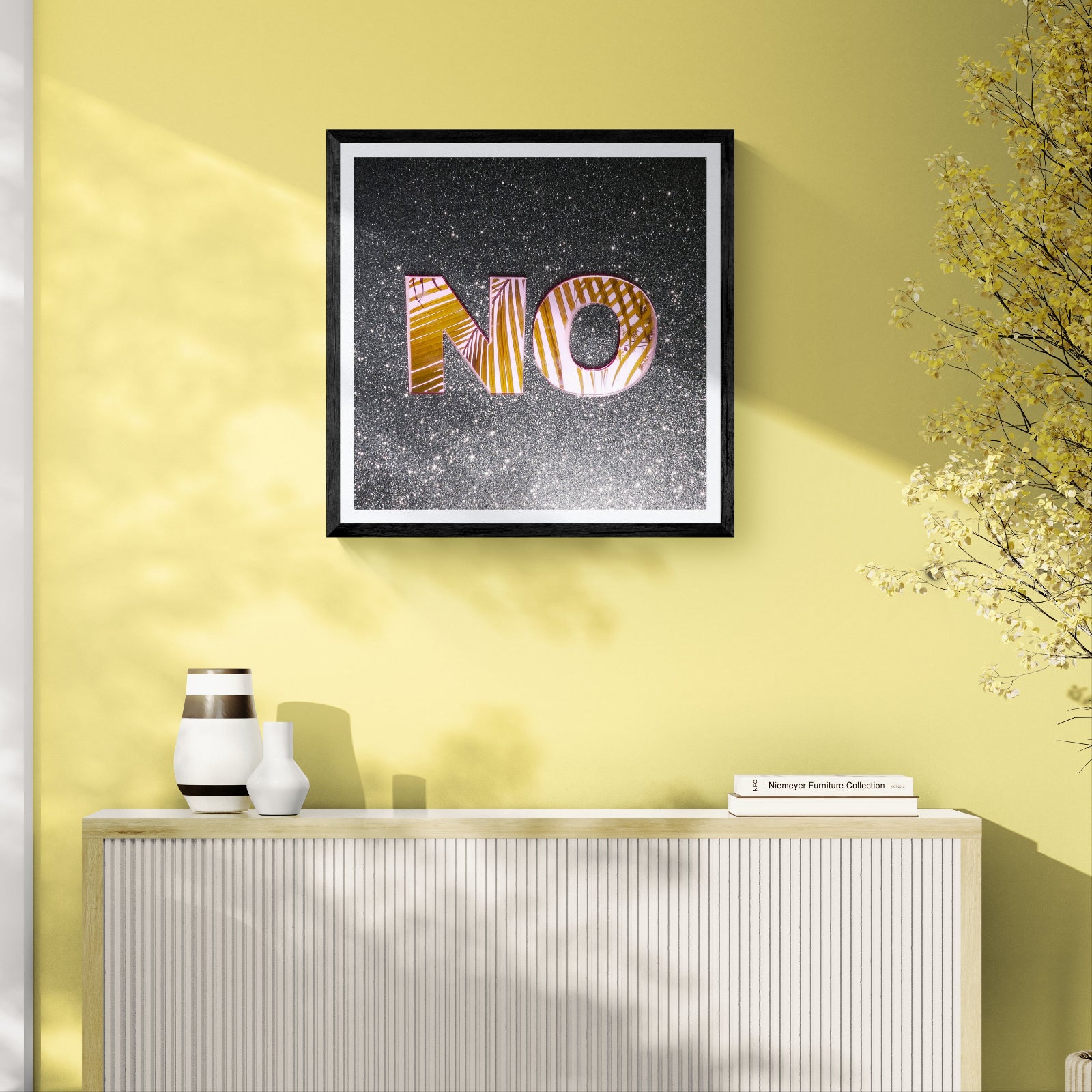 No reflective typography art print on a black glitter background displayed as 30 × 30 wall art in a black frame on a sunlit yellow living room wall.