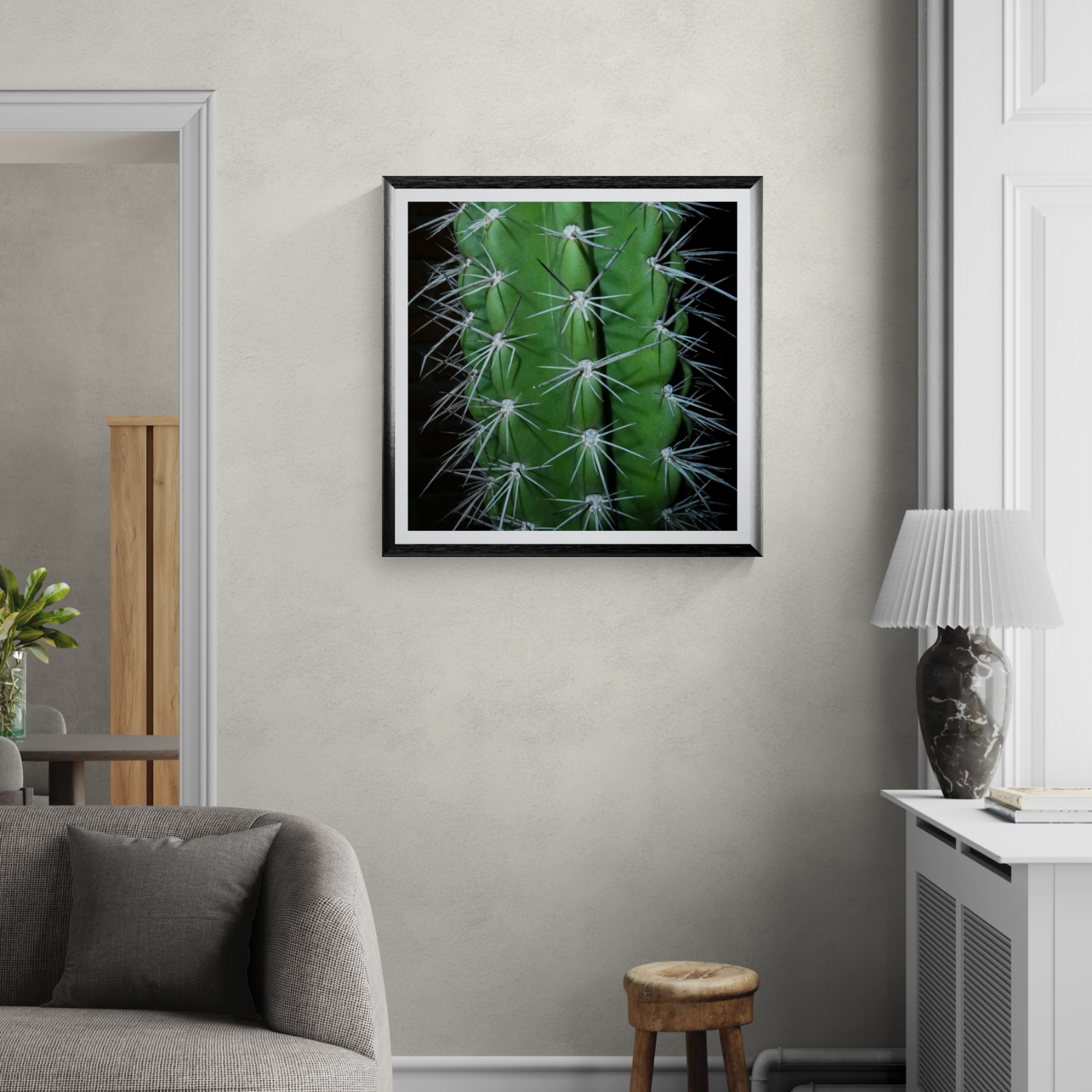 Personal Space cactus photography art print displayed as 30 × 30 wall art in a black frame in a neutral modern living room.